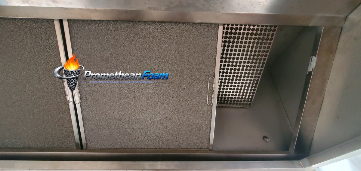 Foam metal grease filters installed in commercial restaurant kitchen hood — NFPA 96 UL 1046 compliant fire prevention solution with 98% grease filtration efficiency